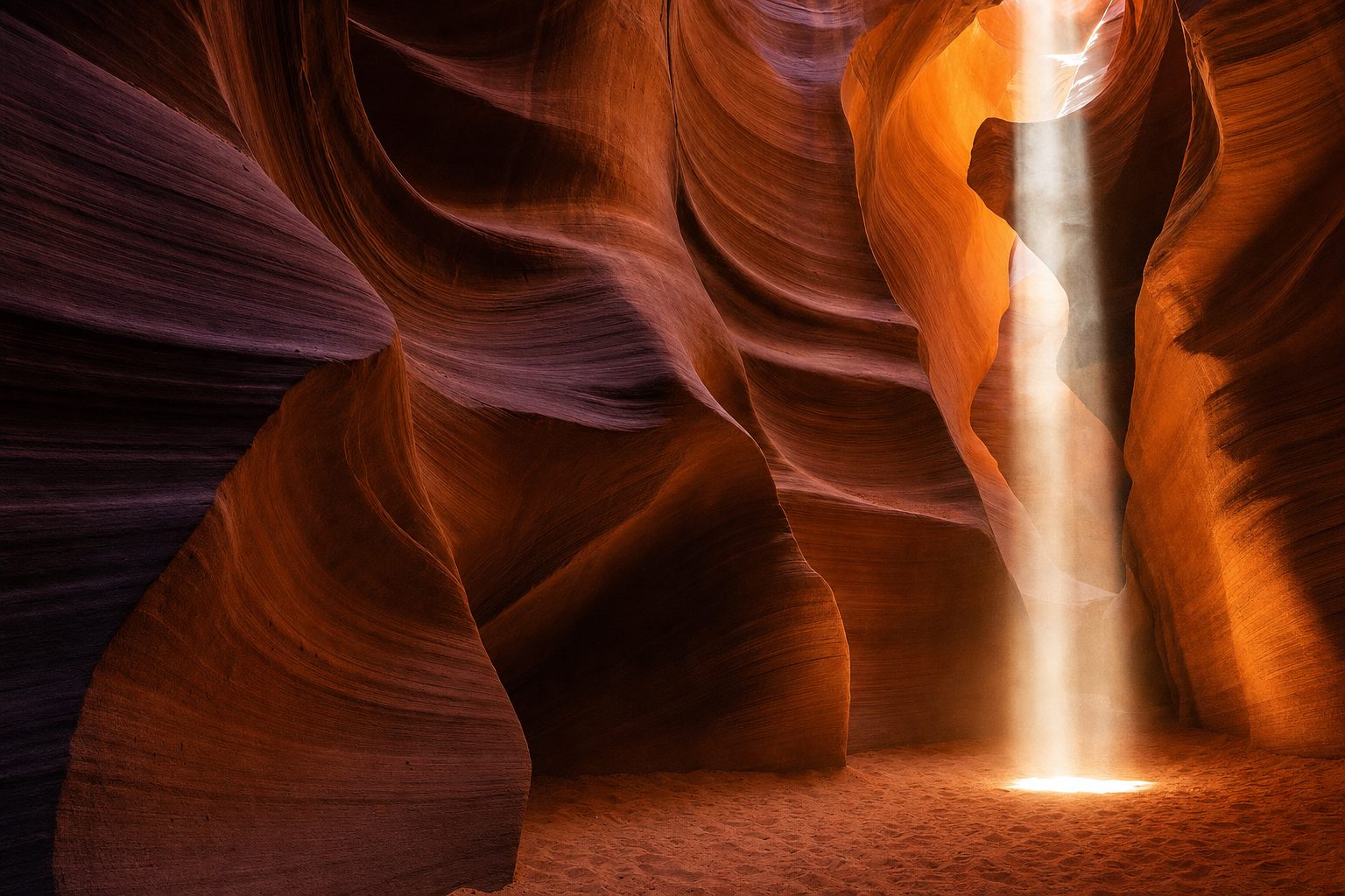 A narrow orange sandstone slot canyon curves through the foreground and midground, with a single soft shaft of midday light illuminating textured walls beneath a clear blue strip of sky, with no people.