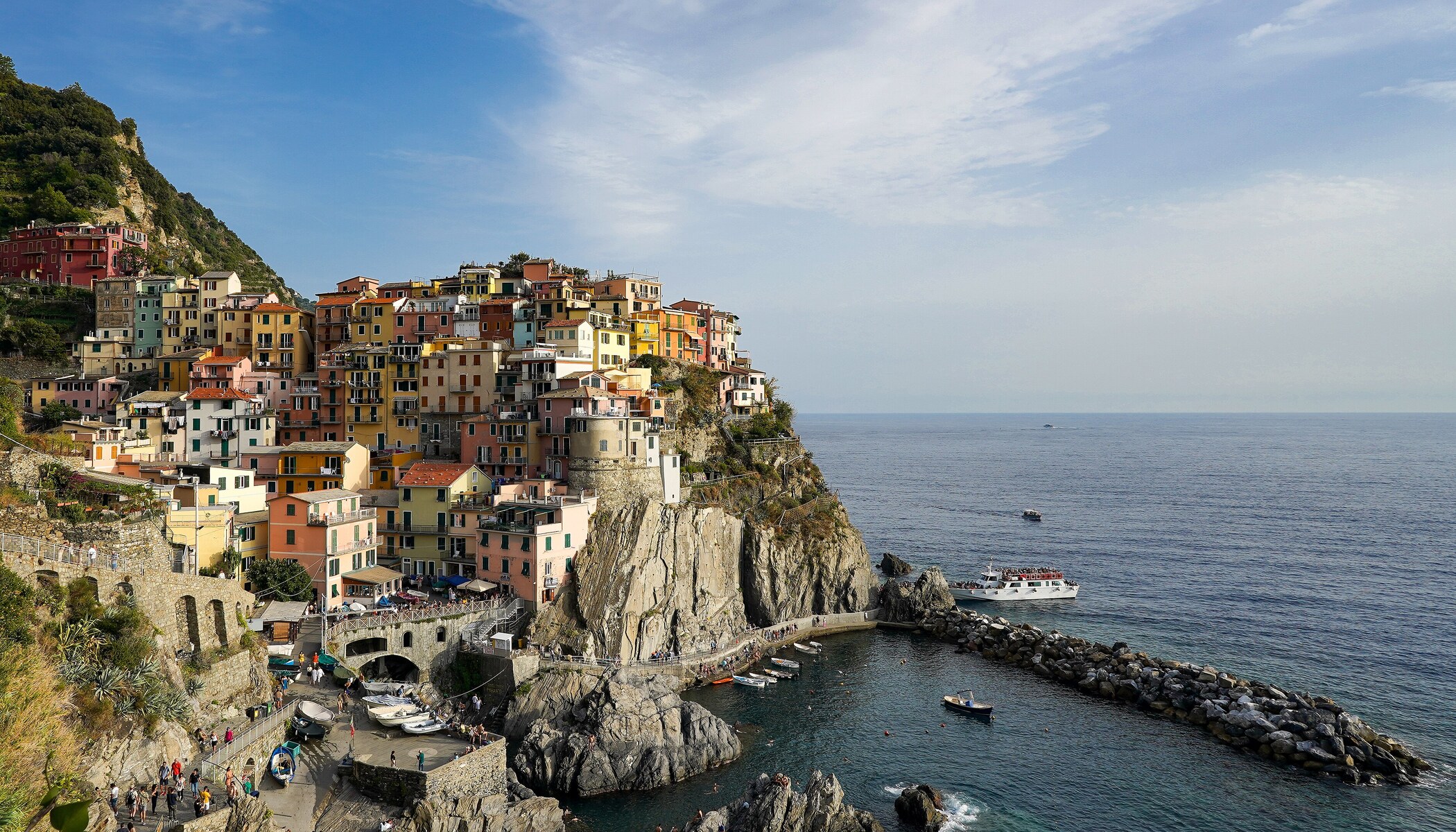 Manarola's colourful houses rise above its rocky harbour on the Cinque Terre coast.