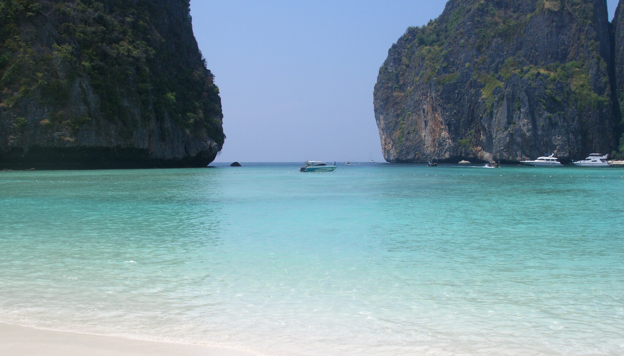 Turquoise water and pale sand at Maya Bay framed by the limestone cliffs of Ko Phi Phi Leh.